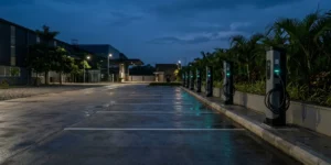 Empty corporate EV depot at dusk with a row of AC charging units, illustrating EV fleet management ROI in India